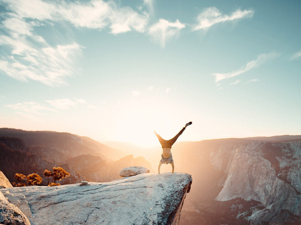 man-doing-hand-stand-on-mountain-2387866