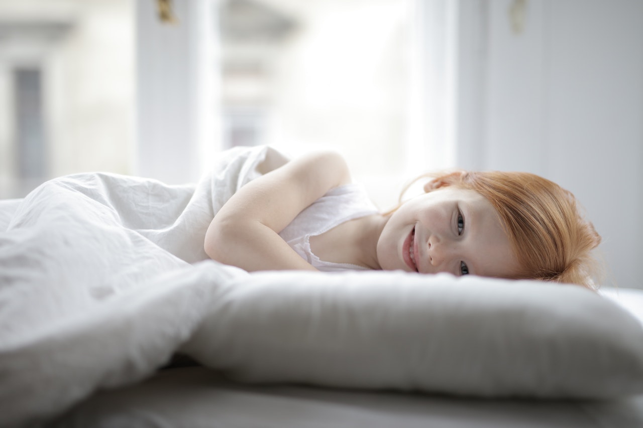 girl-in-white-tank-top-lying-on-bed-3887626.jpg